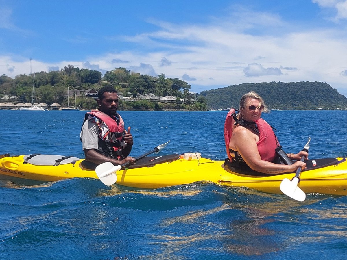 Couple giving thumbs up while kayaking in Port Vila