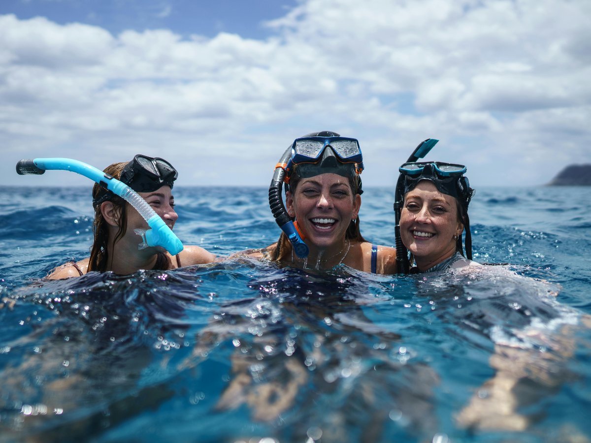 Guests laughing together after snorkelling at Iririki Island