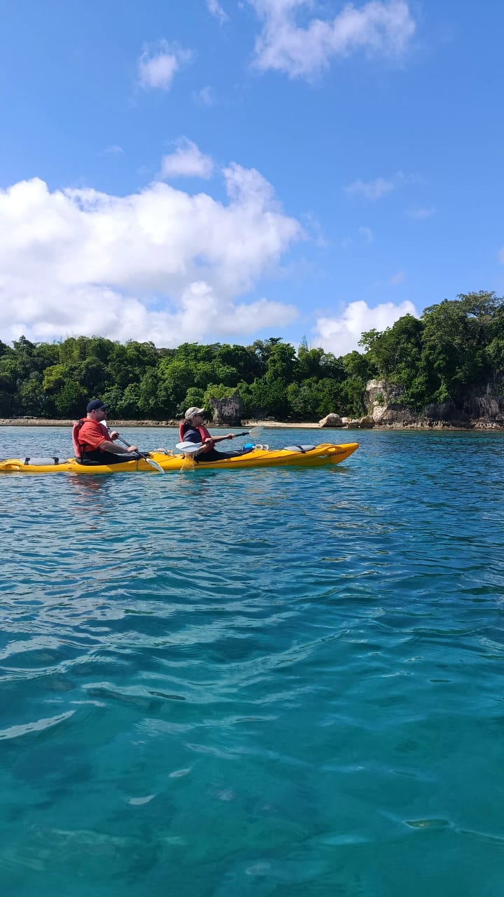 Guests kayaking on clear blue water in Port Vila