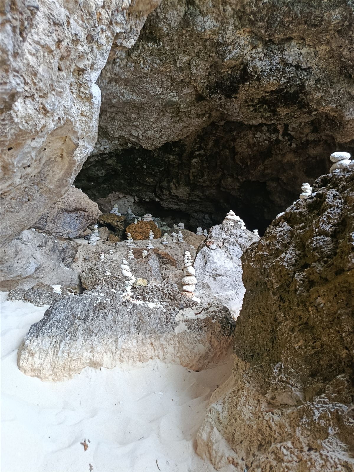 Weathered limestone rock and small cave on the Moso shoreline