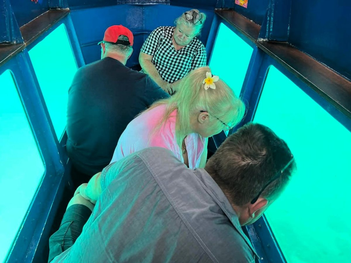 Group viewing marine life through the Reef Explorer semi-submersible windows