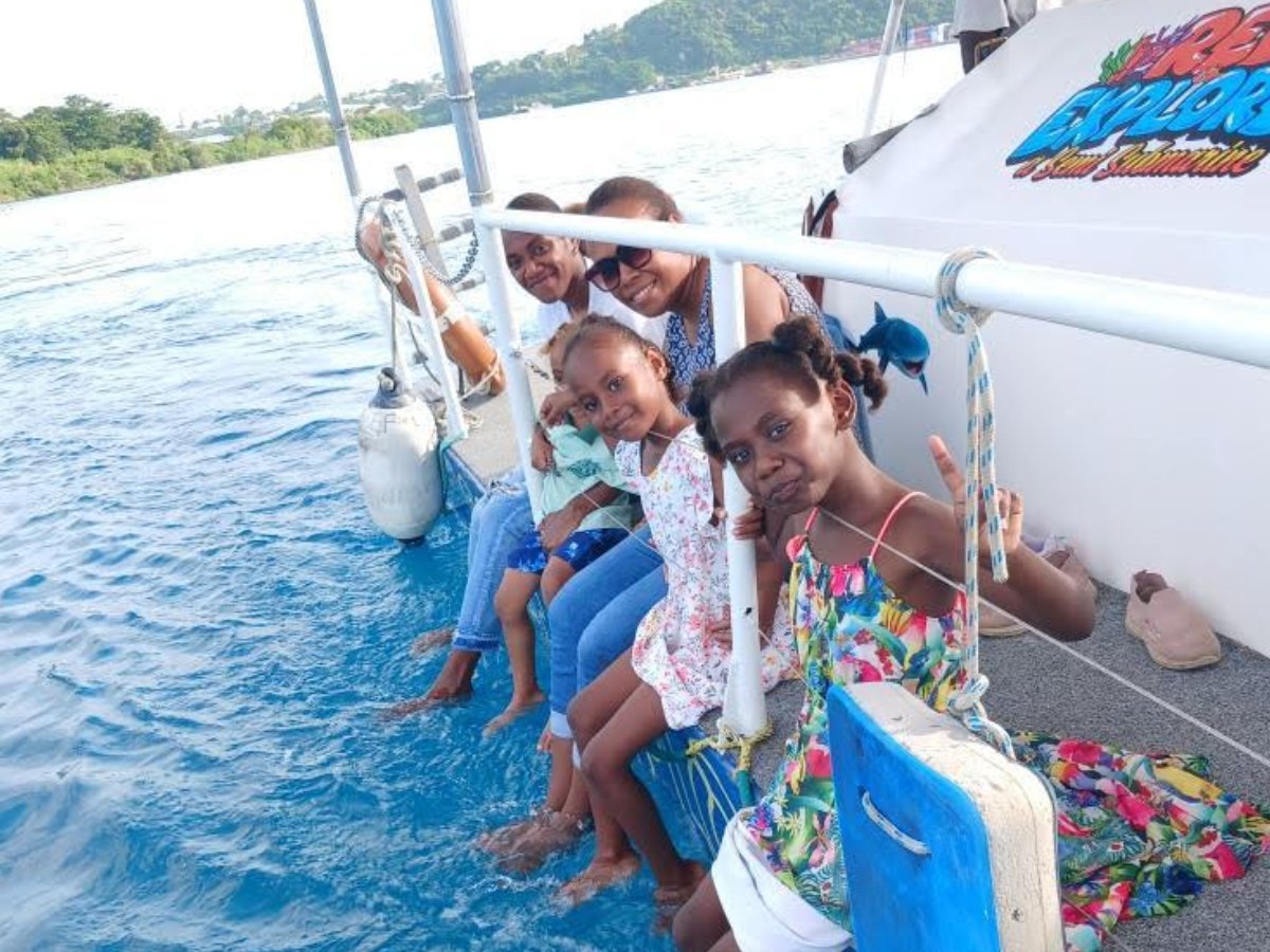 Family relaxing on deck of the Reef Explorer semi-submersible