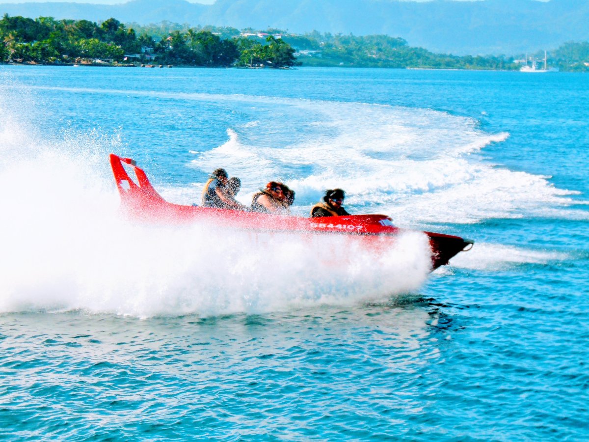 Tropic Thunder Jet boat performing a high-speed turn with dramatic water spray